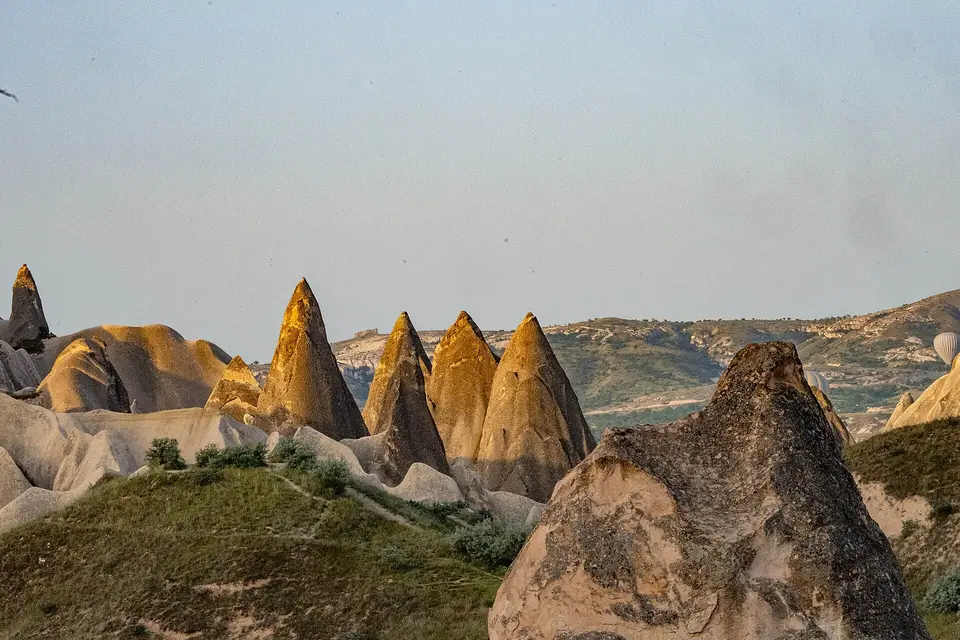 Pointed fairy chimneys in a Cappadocia valley in evening light