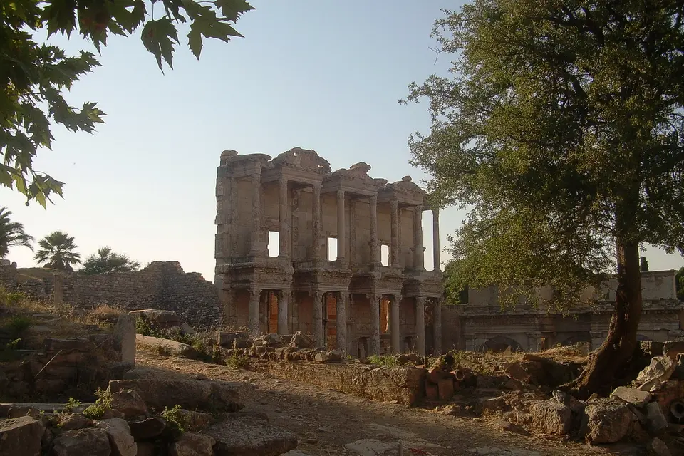 The Library of Celsus in Ephesus framed by trees in soft morning light